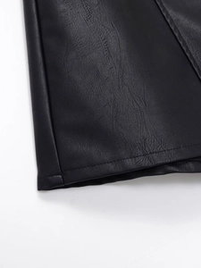 Macro shot of high-quality PU leather texture and precise stitching on black skirt shorts