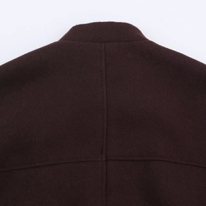 Macro shot of the back collar and neat stitching on this dark burgundy wool coat