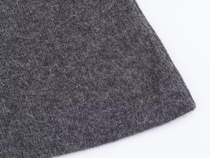 Macro shot of dark gray knitted fabric texture with soft wool fibers for women's cardigan set