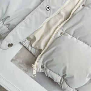 Detailed close-up of metal zipper and snap buttons on a slim-fit PU leather vest