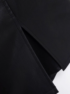 Macro shot of black PU leather texture showing fine lychee grain and stitching details