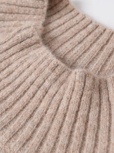Detailed view of beige ribbed knit sweater collar showing soft fabric texture