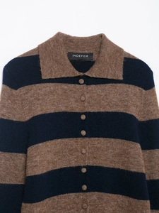 Close-up of polo collar and knit buttons on striped brown and blue knitwear
