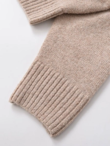 Detailed macro view of the oatmeal knit cuff showing soft ribbed texture and wool blend fabric