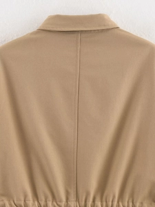 Detail shot of khaki jacket back featuring central vertical seam and adjustable waist pleats