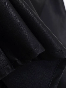 Detailed macro view of black PU leather texture with high-quality flat seam stitching