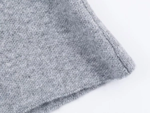 Detailed macro view of the grey knit fabric texture and high-quality stitching detail