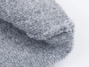 Close-up of gray knit fabric showing dense texture and soft ribbed material detail