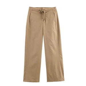 Detail showing khaki wide-leg pants with elastic drawstring waist and metal tips