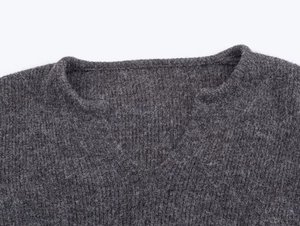 Close-up of the dark grey round neck knit sweater featuring premium brushed wool texture