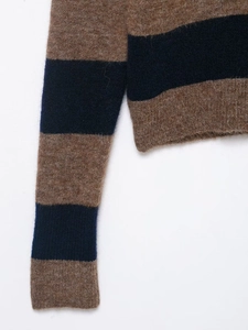 Detail shot of the plush mohair texture and ribbed cuffs of this striped knit sweater