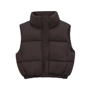 Detail of high collar and puffer texture on a coffee brown cropped winter vest