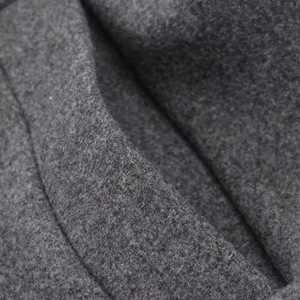 Detailed macro shot of dark grey wool blend fabric texture for autumn winter coats