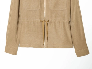 Detailed view of khaki utility jacket with drawstring waist and metal zipper closure