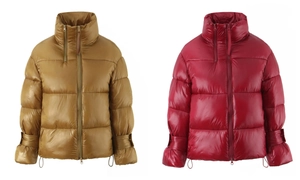 Detail of glossy puffer jackets in yellow and red with high collars and dual zippers