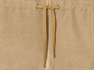 Detail of khaki twill trousers showing metal zipper and adjustable drawstring waist