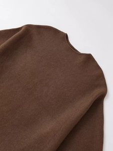Macro shot of dark brown fine knit neckline and texture on causal loose pullover sweater