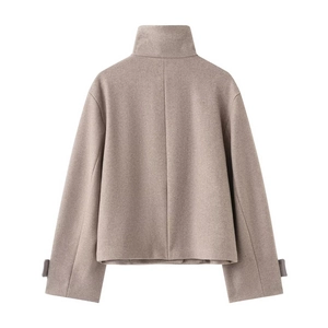 Detail view of the back seam and adjustable cuffs on the brown high collar coat