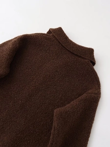 Detail of high-quality brown teddy fleece texture and turn-down collar on jacket