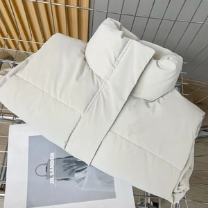 Detail of cream white quilted PU vest with stand collar in a chic metal shopping basket