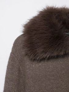 Detail of a deep brown knit cardigan featuring a plush faux fur collar and fine texture
