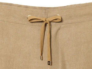 Detail of khaki drawstring waist with gold metal tips and premium twill fabric texture