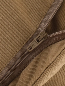 Detailed macro view of the zipper on brown corduroy jacket showing fabric texture