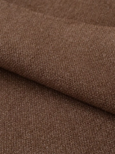 Close-up macro of brown knitted fabric texture showing thick soft wool fibers