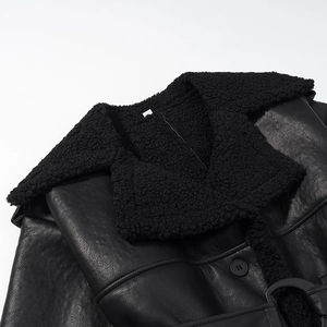 Close-up of black PU leather coat featuring plush faux fur collar and button detail
