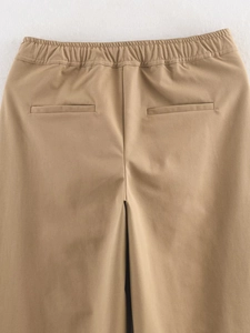 Close-up of khaki casual pants featuring elastic drawstring waist and symmetric back pockets