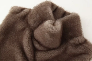 Detailed close-up of premium brown faux fur texture showing soft plush and luxury fibers