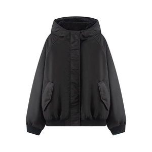 Detail of black hooded bomber jacket showing ribbed cuffs and windproof pocket flaps