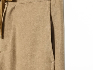 Close-up of khaki casual pants featuring elastic drawstring waist and side flat pockets