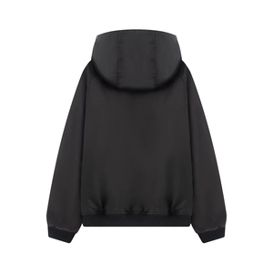 Detail view of black oversized bomber jacket back with ribbed cuffs and raglan sleeves