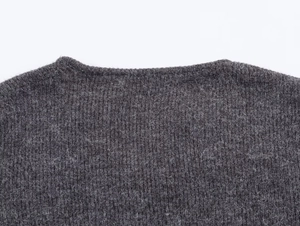 Detailed macro view of dark grey mohair knit collar with fluffy textured finish