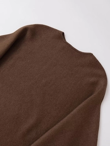 Detail of the fine knit texture and smooth round neckline on a brown casual sweater