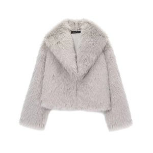 Detailed view of plush light grey faux fur texture and brand label on short coat