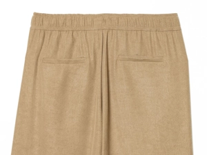 Detail of khaki trousers featuring an elastic waistband and dual welt rear pockets