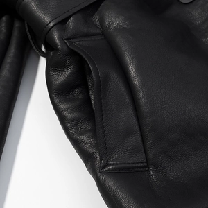 Detailed macro view of black PU leather texture and stitching on the jacket pocket