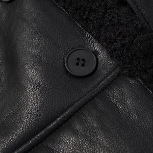 Macro shot of high-quality black leather texture with plush faux fur lining and button