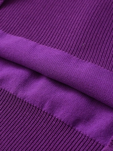 Macro shot of dark purple knit fabric showing ribbed texture and fine stitching detail