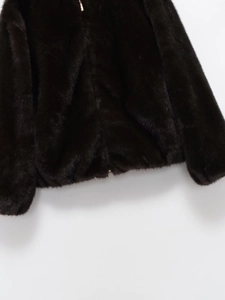 Détail de l'ourlet élastique et de la texture en fausse fourrure sur la veste d'hiver