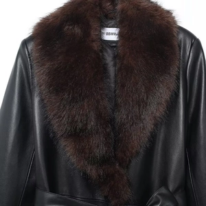 Detail of black faux leather jacket featuring a plush brown detachable faux fur collar