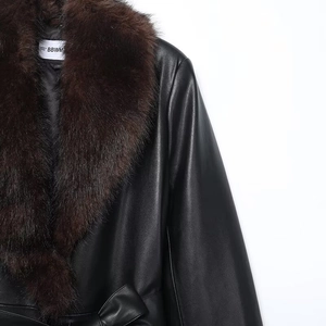 Detail of a black PU leather jacket featuring a plush detachable brown faux fur collar