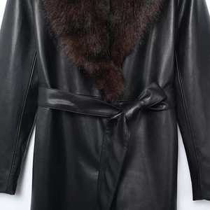 Detail of black PU jacket featuring a detachable plush brown faux fur collar and belted waist