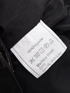 Detailed care label showing 100% polyester fabric material and machine wash instructions