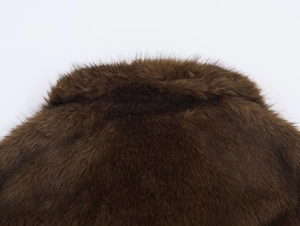 Detailed close-up of premium brown faux fur collar with soft fluffy texture and sheen