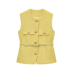 Detailed texture of yellow tweed vest featuring vintage gold buttons and a matching belt