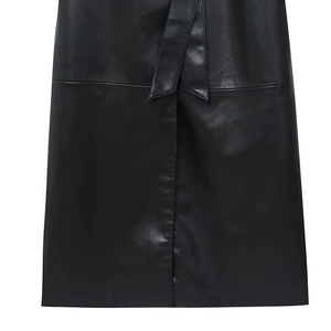 Detail of the high-quality faux leather texture and waist tie design on a black skirt