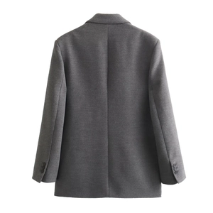Detail of dark grey blazer showing buttoned cuffs and structured back seam tailoring